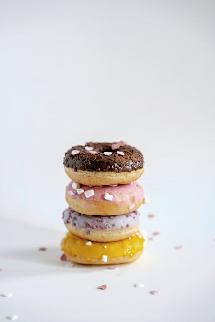 Food Aesthetics - Vertical stack of four assorted donuts with icin #11150325