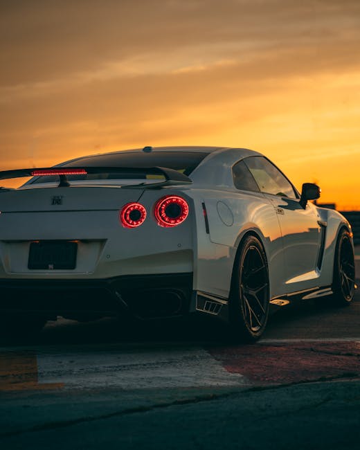 Luxury Cars - A white Nissan GT-R sports car captured at sunse #11941023