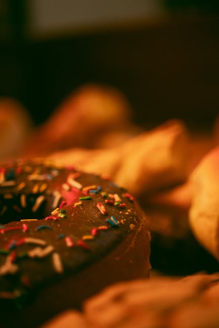 Food Aesthetics - Close-up of a chocolate donut with vibrant sprin #17399995