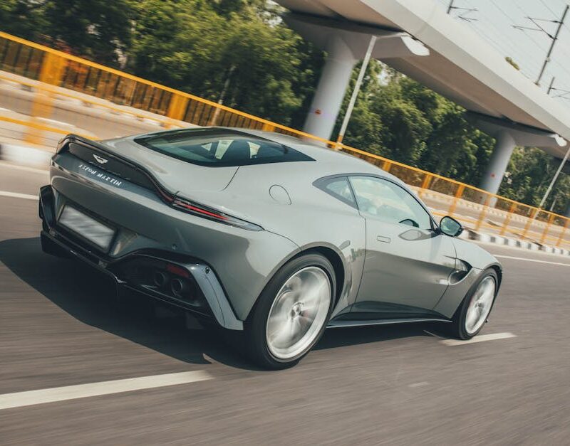 Luxury Cars - Sleek Aston Martin Vantage zooming on a highway #19986973