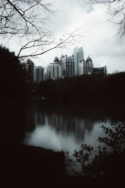 City Architecture - Moody city skyline with a lake reflection on an #35420320