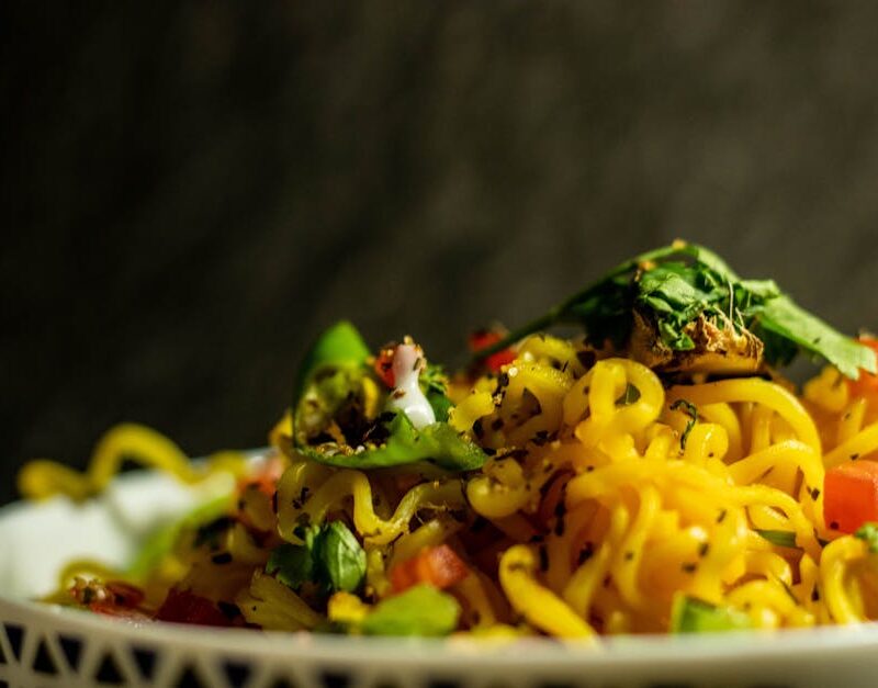 Food Aesthetics - Close-up of a vibrant Indian noodle dish garnish #4635600