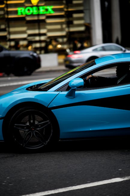 Luxury Cars - Capture of a sleek blue supercar driving through #6152800